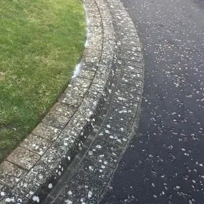 Block paving edge on a driveway, dull and dirty before cleaning