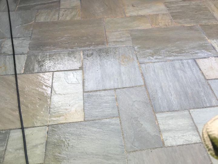 Grey stone patio slabs after cleaning
